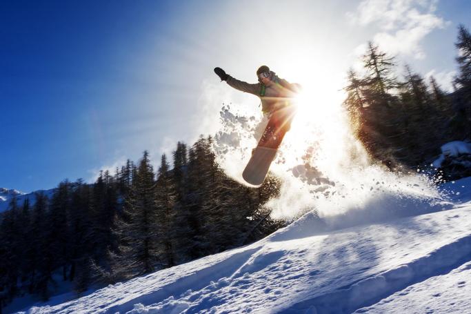 Big Bear Frontier | Big Bear Lake, California | Snowboarder jumping in air while while flinging snow in air