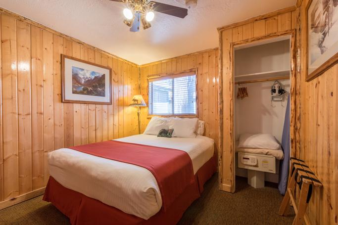 Big Bear Frontier | Big Bear Lake, California | bed in room with wood panelled walls