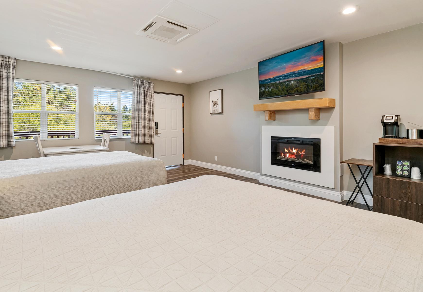 Big Bear Frontier | Big Bear Lake, California | two beds facing television and fireplace
