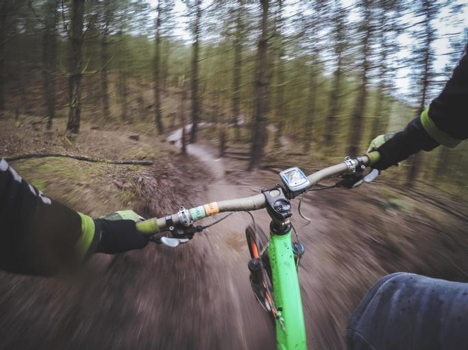 Big Bear Frontier | Big Bear Lake, California | Person's hands on handlebars of bike riding down trail