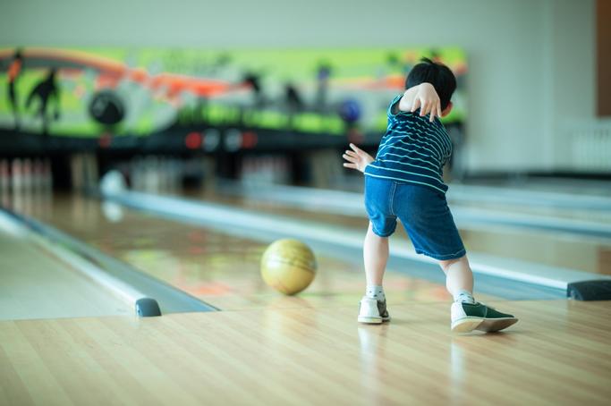 Big Bear Frontier | Big Bear Lake, California | Little boy throwing bowling ball towards pins